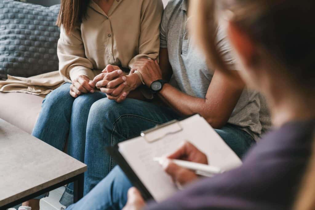 Couple meeting with therapist during family therapy for addiction in New Jersey counseling session
